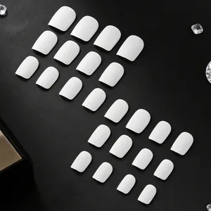Short matte white press-on nails set with 24 pieces on a textured black background