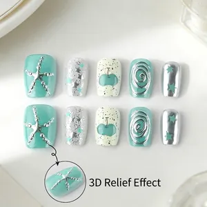Short mint green press-on nails with 3D silver embossing and shiny star textures