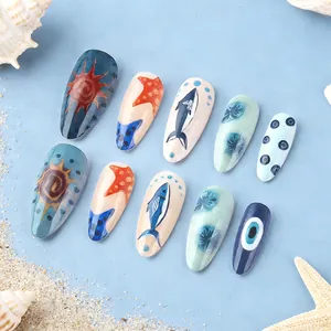 Ocean-themed almond nails with starfish, shark and shell art on blue and beige base