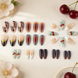 Glossy almond press-on nails with leopard patterns, 3D gold accents, and cherry designs