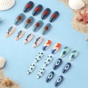 Detailed view of ocean-themed press-on nails with blue patterns and beach decor