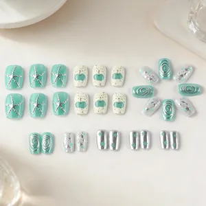 Short square mint green press-on nails set with silver starfish and metallic details