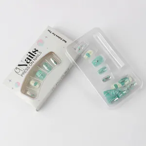 Detail of mint green sea-themed press-on nails with silver starfish and glitter accents