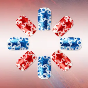 Close-up of short glossy press-on nails with red and blue glitter stars on white base
