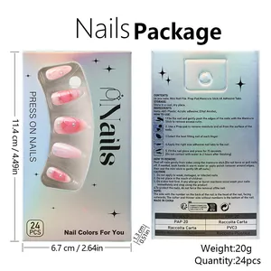 Detail view of pink gradient press-on nails with gold lines and pearl accents in packaging
