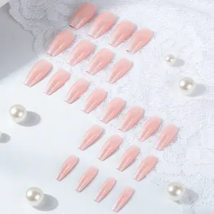Detail view of 24 pieces pink glitter press-on nails on elegant white lace background