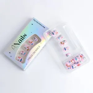 Detail of pink press-on nails with fish and coral ocean patterns in a laser box