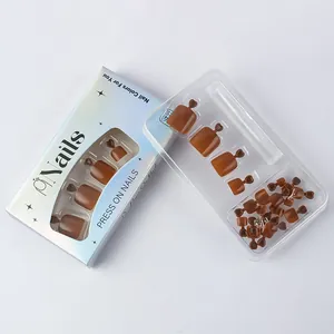 Detailed view of caramel brown glossy press-on toe nails in minimalist packaging box