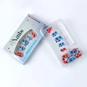 Detail of red and blue star press-on nails in silver packaging with transparent window