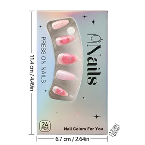 Detail of almond-shaped pink gradient press-on nails with gold lines and rhinestones