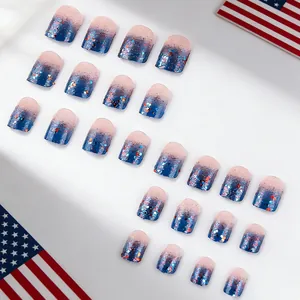 Close-up of pink and blue gradient French press-on nails with star-shaped glitter