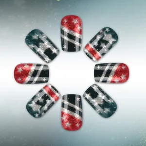 Detail of red and black glitter press-on nails with silver star and stripe patterns
