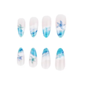 Detail of sea star patterns and ocean wave textures on blue gradient almond false nails