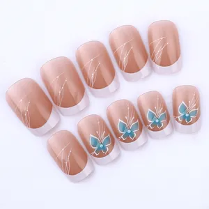 Detail of short square press-on nails with blue butterfly patterns and French tip design