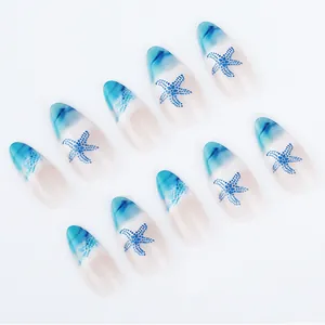 Close-up of almond ocean nails featuring blue starfish patterns and sea wave gradients