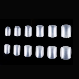 Detailed view of semi-transparent pearlescent white square press-on nails set on black background