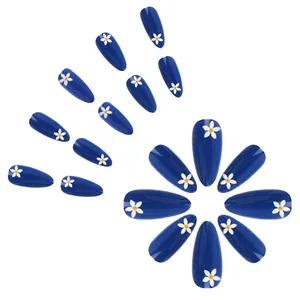 Glossy navy blue press-on nails with white daisy floral design in long almond shape