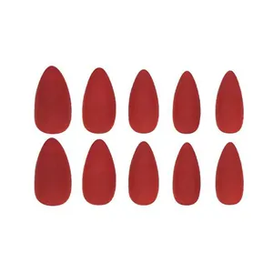 Short red matte press-on nails with gold rhinestone accents in almond shape