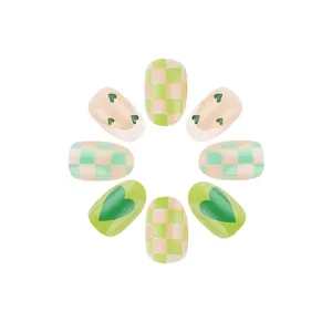 Green and cream oval press-on nails with checkerboard and heart French patterns