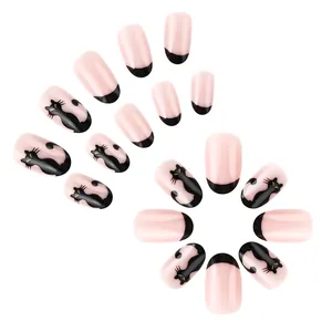 Detailed view of Halloween nude pink false nails with black cat art and French tips