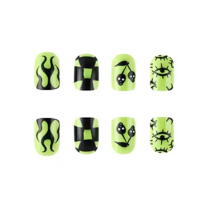 Glossy Halloween short press-on nails featuring neon green and black punk art designs