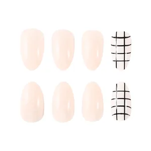 Detail of short almond press-on nails featuring nude pink polish and black grid patterns