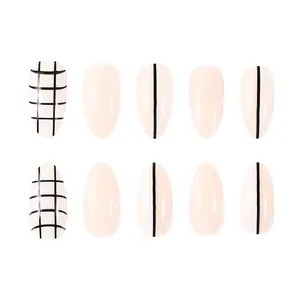Short almond press-on nails with minimalist black and white grid and line patterns