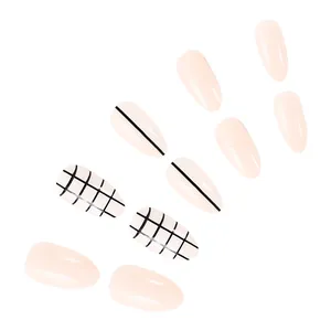 Macro detail of almond press-on nails featuring nude pink tones with black grid patterns