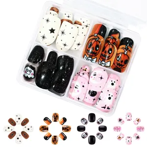 Macro view of Halloween nail art set with pumpkin and ghost designs in a clear box