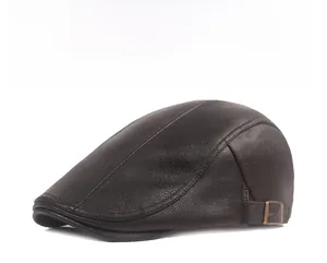 Close-up of brown leather flat cap with lychee texture and side metal buckle