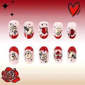 Detail of short pink press-on nails with red French tips and retro tattoo rose art