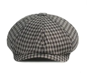 Detailed view of the classic houndstooth newsboy cap with wool blend fabric texture