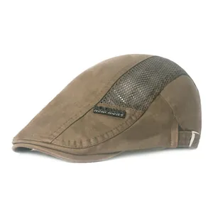 Close-up of brown mesh beret hat showing breathable fabric texture and side brand logo