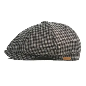 Classic houndstooth newsboy cap with leather tag and thick wool blend texture