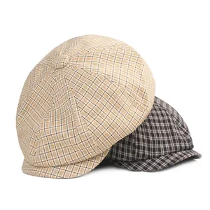 Classic houndstooth newsboy caps in khaki and dark grey checkers on white background