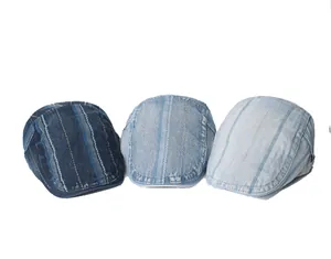 Vertical striped denim beret caps in three shades of washed blue flat lay display
