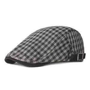 Detail of grey plaid beret showing metallic side buckle and premium fabric texture