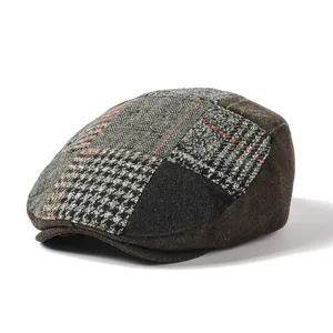 Detail shot of vintage tweed patchwork newsboy cap showing herringbone and plaid textures