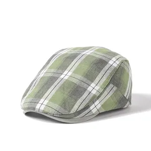 Detailed view of the plaid newsboy cap showing green and grey tartan pattern texture
