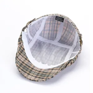 Inside view of a gray-yellow plaid cotton flat cap with white lining and size label