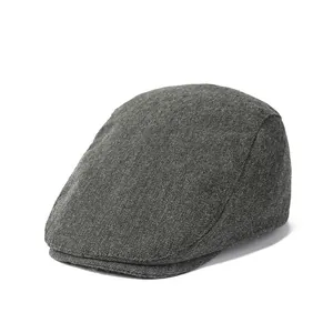 Detailed close-up of dark grey twill texture on a vintage British style flat cap