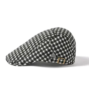 Close-up of black and white checkered ivy cap with vintage metal side buckle detail