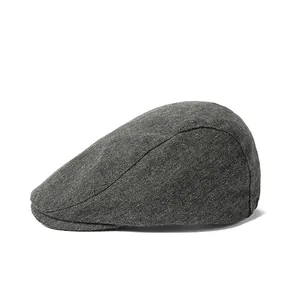 Close-up of side view showing grey tweed fabric texture of the vintage beret flat cap