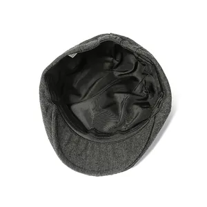 Detail view of newsboy cap interior showing grey tweed fabric and black satin lining