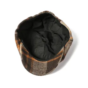 Detail showing the black fabric lining and plaid pattern of this retro newsboy cap