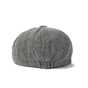 Close-up of black and white herringbone pattern wool newsboy cap for men
