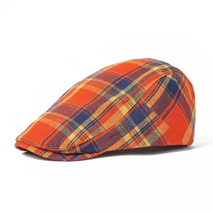 Detailed side view of the orange plaid flat cap showing fabric texture and seams