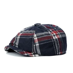 Classic blue and red plaid newsboy cap with octagonal crown and short brim on white background