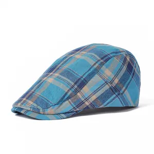 Side view of blue plaid flat cap showing textured fabric and structured brim detail