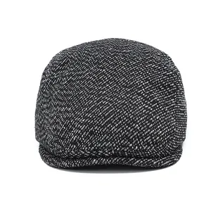 Men's winter flat cap in black and white tweed fabric with classic salt and pepper pattern